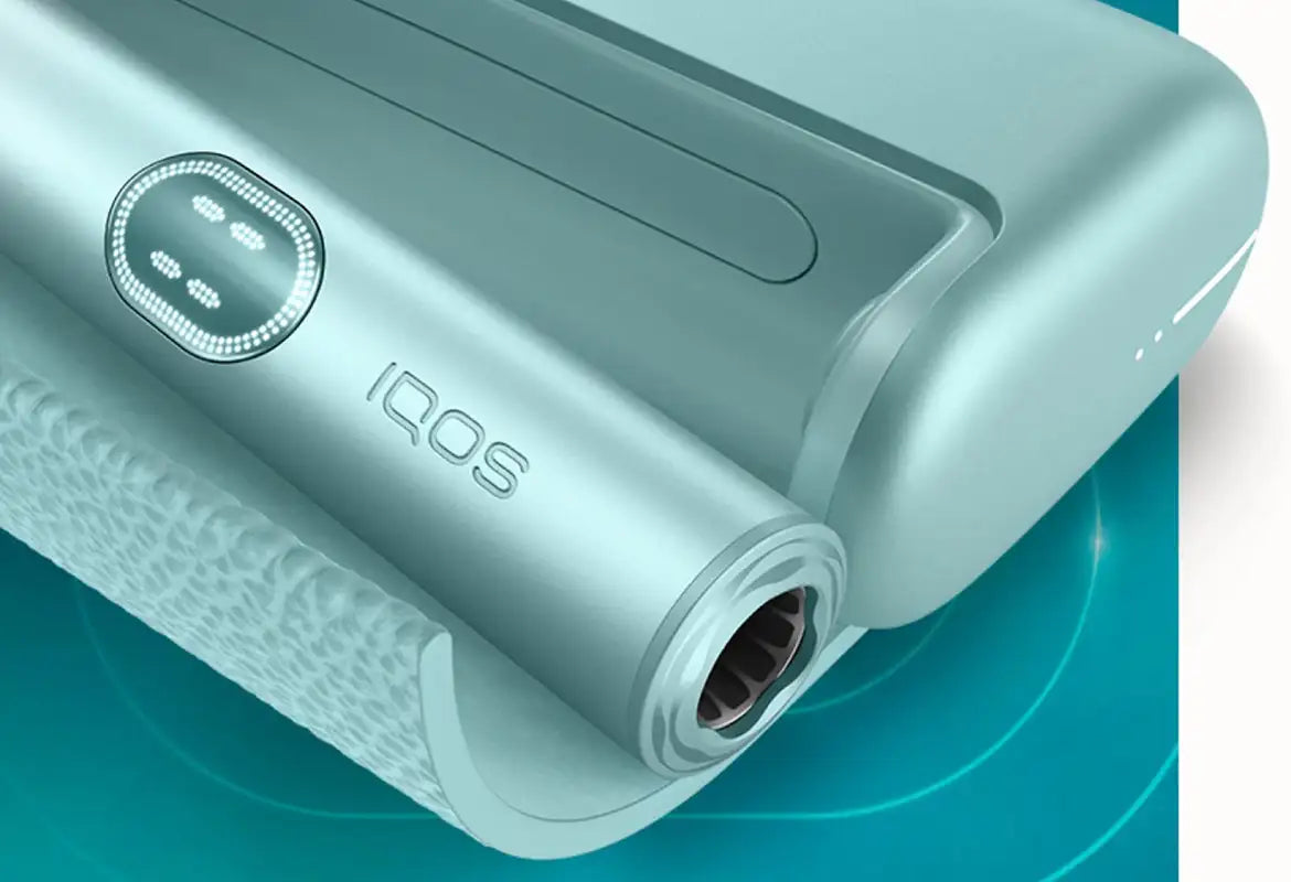 A sleek, light blue iqos heating device with a textured grip and circular control button.